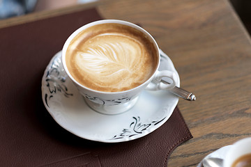 Image showing view of cappuccino served on wooden table