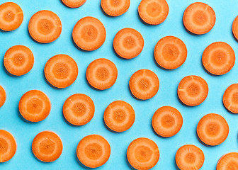 Image showing sliced carrot on blue background