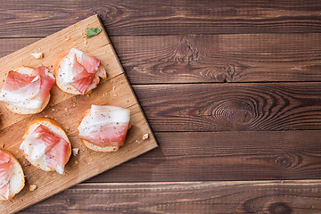 Image showing Bread and bacon, wooden board