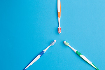 Image showing Three toothbrushes on empty background