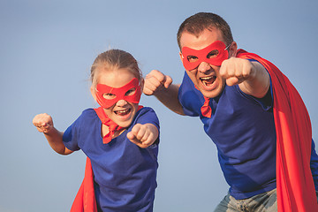 Image showing Father and daughter playing superhero outdoors at the day time.