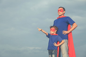 Image showing Father and son playing superhero outdoors at the day time.