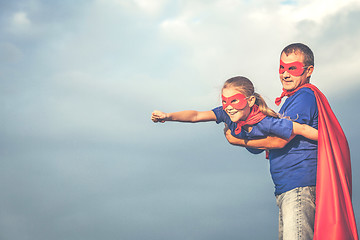 Image showing Father and daughter playing superhero outdoors at the day time.