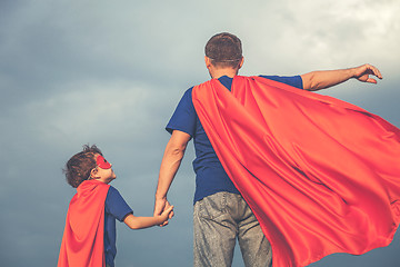 Image showing Father and son playing superhero outdoors at the day time.