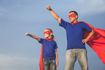 Image showing Father and daughter playing superhero outdoors at the day time.