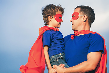 Image showing Father and son playing superhero outdoors at the day time.