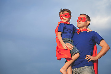Image showing Father and son playing superhero outdoors at the day time.