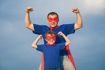 Image showing Father and son playing superhero outdoors at the day time.