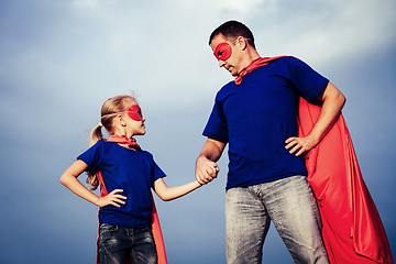 Image showing Father and daughter playing superhero outdoors at the day time.