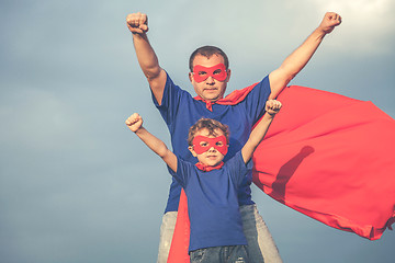 Image showing Father and son playing superhero outdoors at the day time.