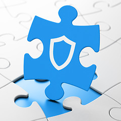 Image showing Safety concept: Contoured Shield on puzzle background