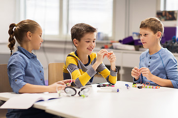 Image showing happy children building robots at robotics school