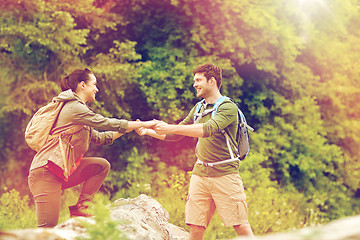 Image showing smiling couple with backpacks hiking