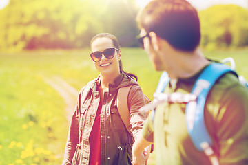 Image showing happy couple with backpacks hiking outdoors