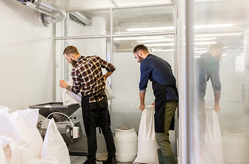 Image showing men with malt bags and mill at craft beer brewery