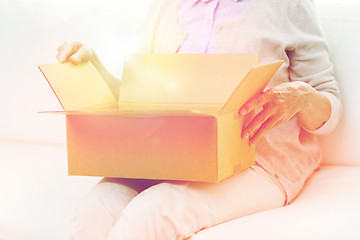 Image showing close up of senior woman with parcel box at home