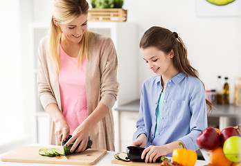 Image showing happy family cooking dinner at home kitchen