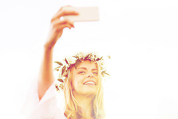 Image showing happy young woman taking smartphone selfie