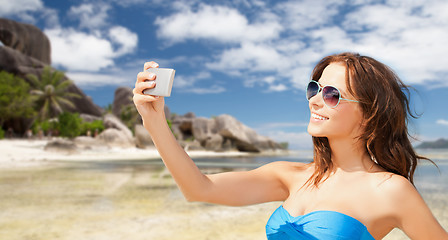 Image showing woman in swimsuit taking selfie with smatphone