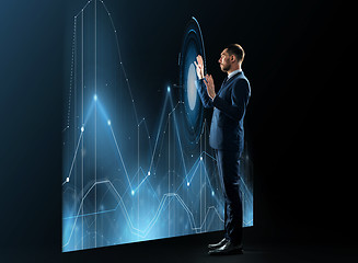Image showing businessman working with virtual chatrs projection