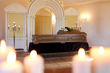 Image showing burning candles and coffin in church at funeral