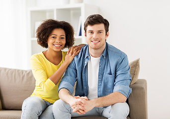 Image showing happy smiling international couple at home