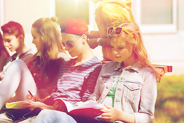 Image showing group of students with notebooks at school yard