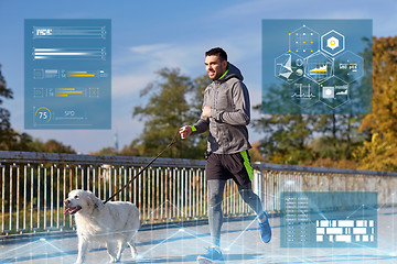 Image showing happy man with labrador dog running outdoors