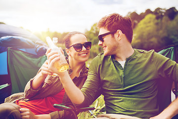 Image showing happy couple clinking drinks at campsite tent