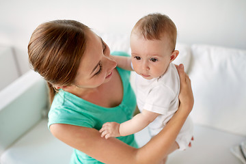 Image showing happy young mother with little baby at home