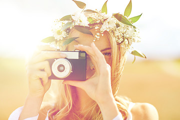 Image showing happy woman with film camera in wreath of flowers