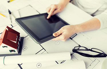 Image showing close up of hand with blueprint and tablet pc