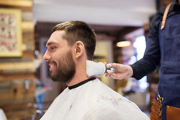 Image showing barber with brush cleaning male neck at barbershop