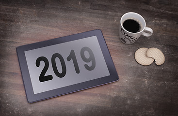 Image showing Tablet touch computer gadget on wooden table - 2019