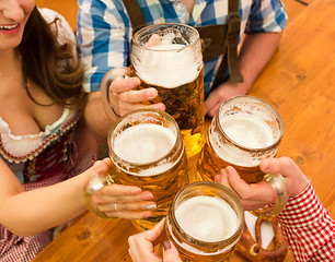 Image showing Young couple toasting in Oktoberfest beer tent