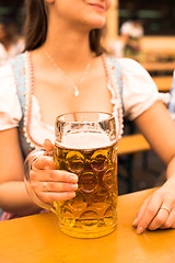 Image showing Beautiful young woman with beer stein at Munich Oktoberfest