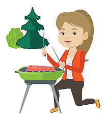 Image showing Woman cooking steak on barbecue grill.