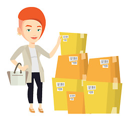 Image showing Business woman checking boxes in warehouse.