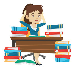 Image showing Student sitting at the table with piles of books.