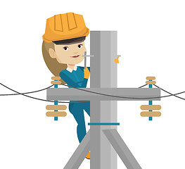 Image showing Electrician working on electric power pole.