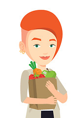 Image showing Happy woman holding grocery shopping bag.