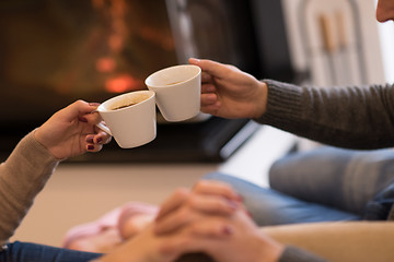 Image showing Young couple  in front of fireplace