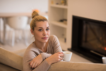 Image showing woman with a mug near a fireplace