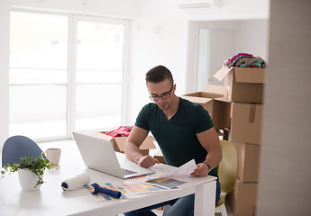 Image showing Young man moving in a new home