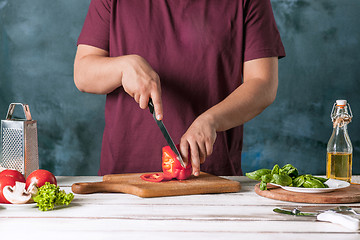 Image showing Closeup hand of chef baker making pizza at kitchen