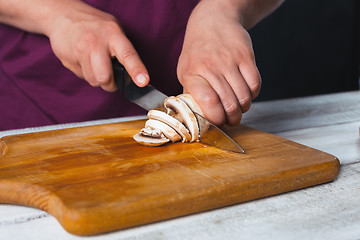 Image showing Closeup hand of chef baker making pizza at kitchen