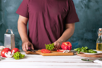 Image showing Closeup hand of chef baker making pizza at kitchen