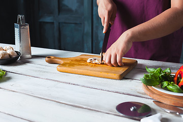 Image showing Closeup hand of chef baker making pizza at kitchen