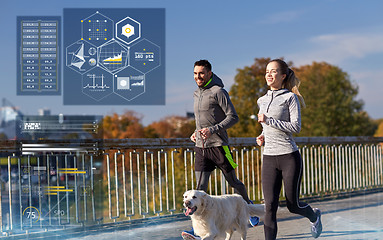 Image showing happy couple with dog running outdoors