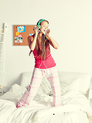 Image showing happy woman in headphones ihaving fun at home